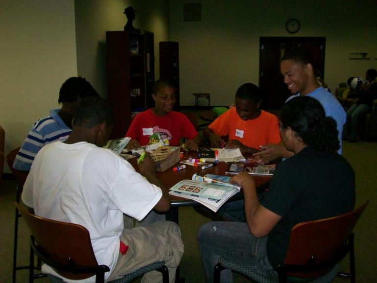 Students sit around a table
