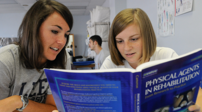 Reading Header Pre-PT Advisement Two students read a textbook