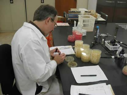 Research Lab Scientist conducts tests using beakers