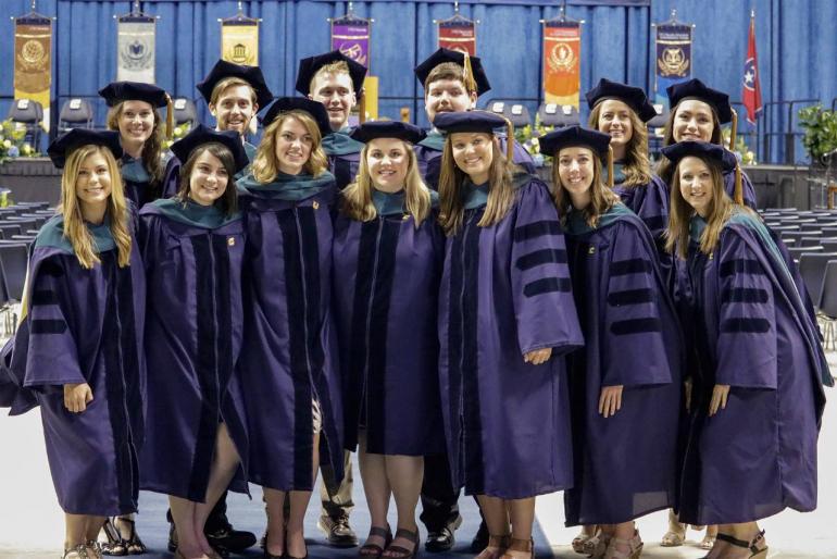Post Ceremony Grads Spring 2017 Group of students pose in graduation gowns