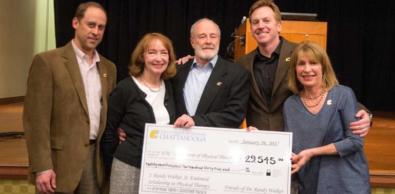 PT Faculty hold a giant check