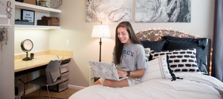 Girl in bedroom her laptop