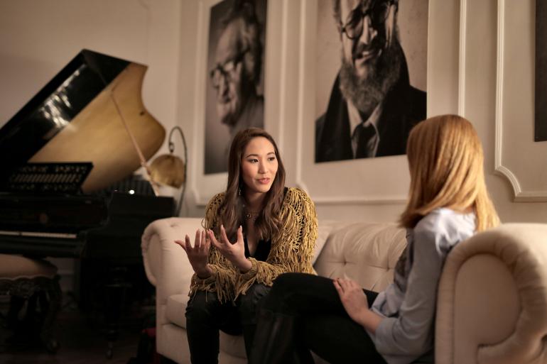 Two women next to piano