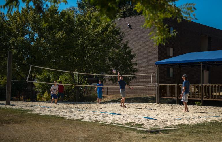 students playing volleyball at lockmiller apartments