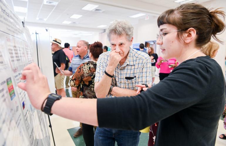 Female Student explaining her research to a professor