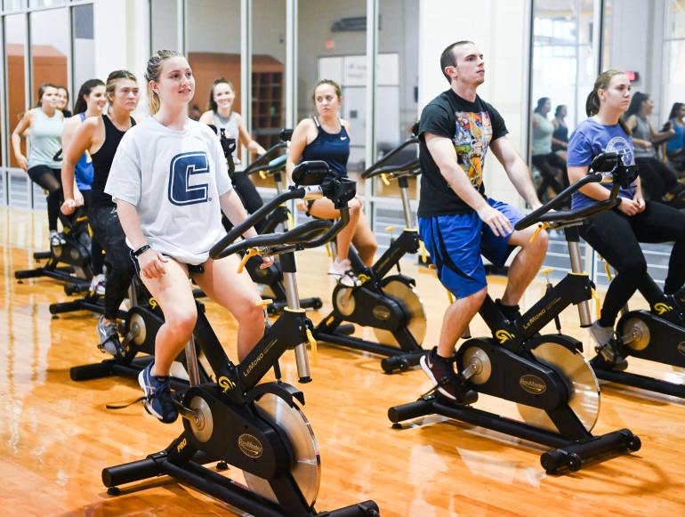 Launch Week Cycle This picture shows multiple people participating in a cycle class in the UTC Aquatic and Recreation Center