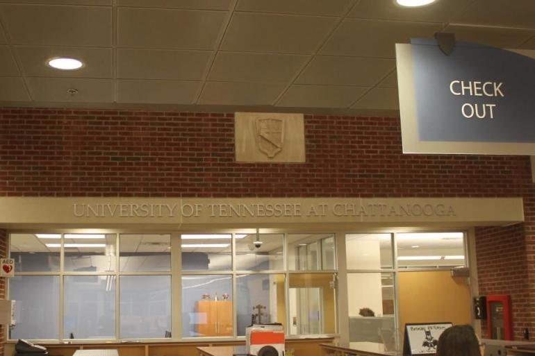 Also above the Check Out desk on the 1st floor is a reproduction of the University shield, which was created in 1915. 