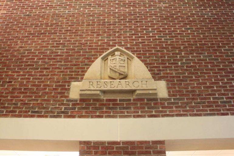 The “Research” shield came from the Industrial Research building that once stood between Lupton Library and the Crossroads, which was torn down when they started building Lupton Library in 1971. 