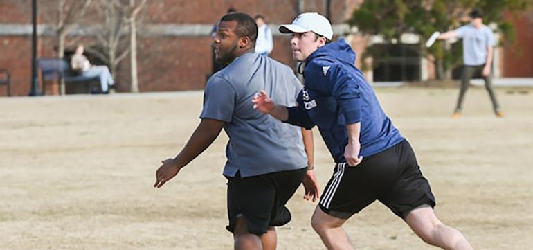 Students playing frisbee