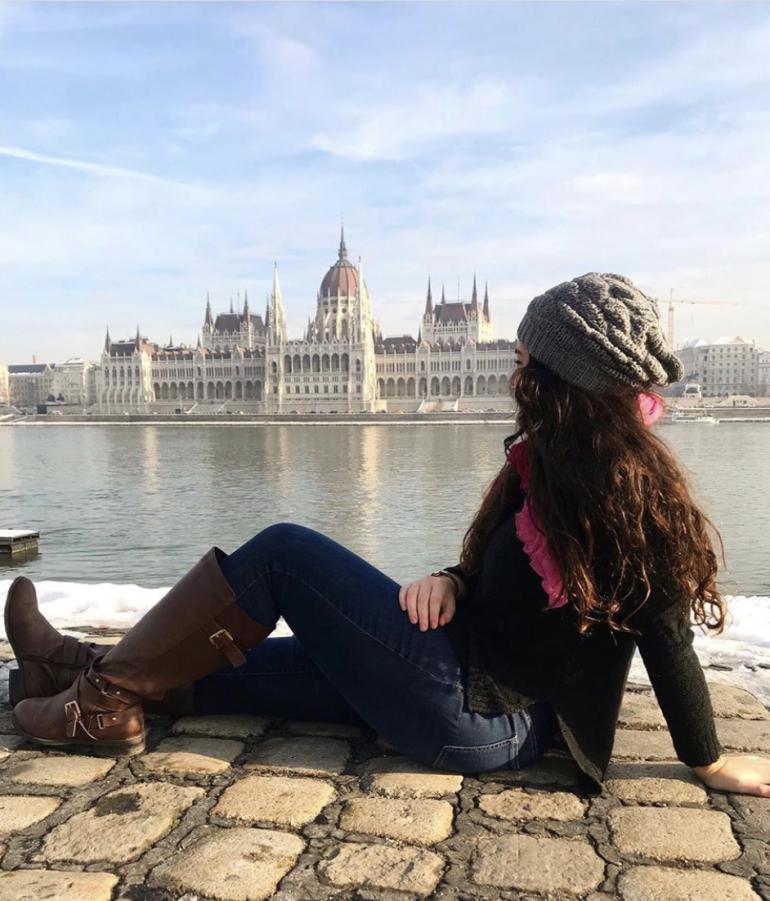 Girl sitting by the water 