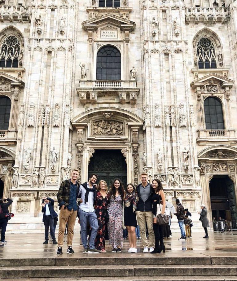 Students posing in front of building in Spain