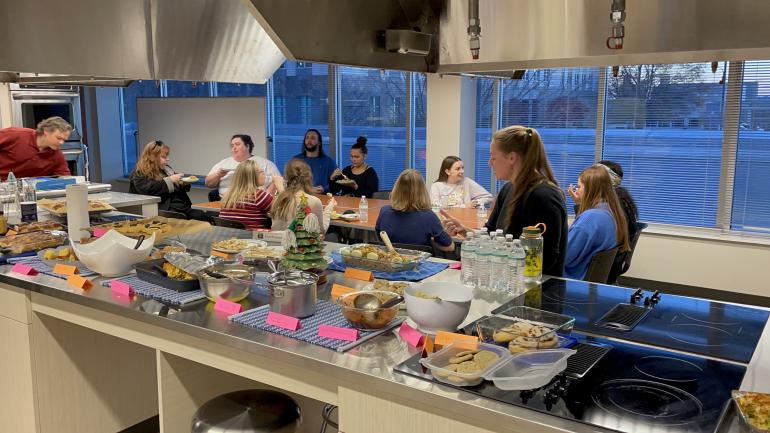 MPH students eating at a table in large kitchen
