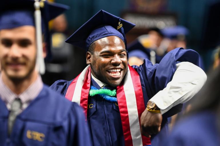 A student smiling at the commencement ceremony