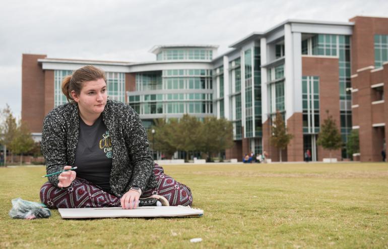 student drawing outside