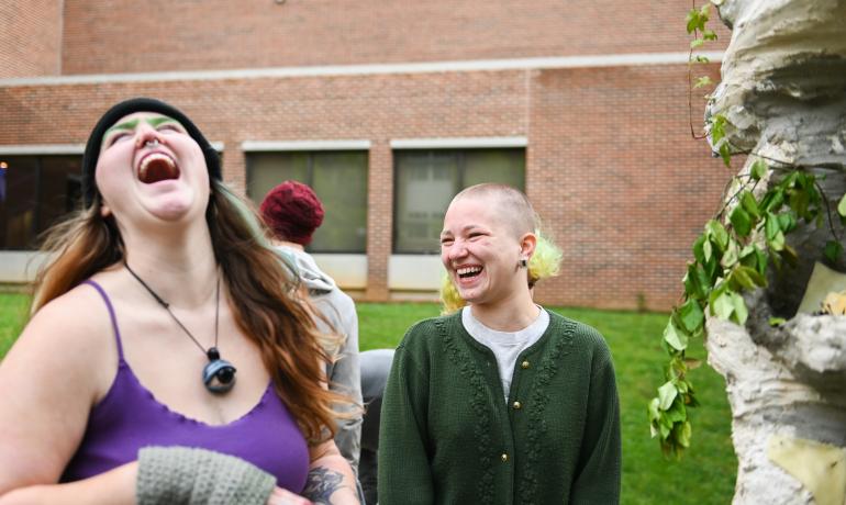 students laughing outside the FAC