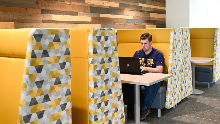 student studying in West Campus booth