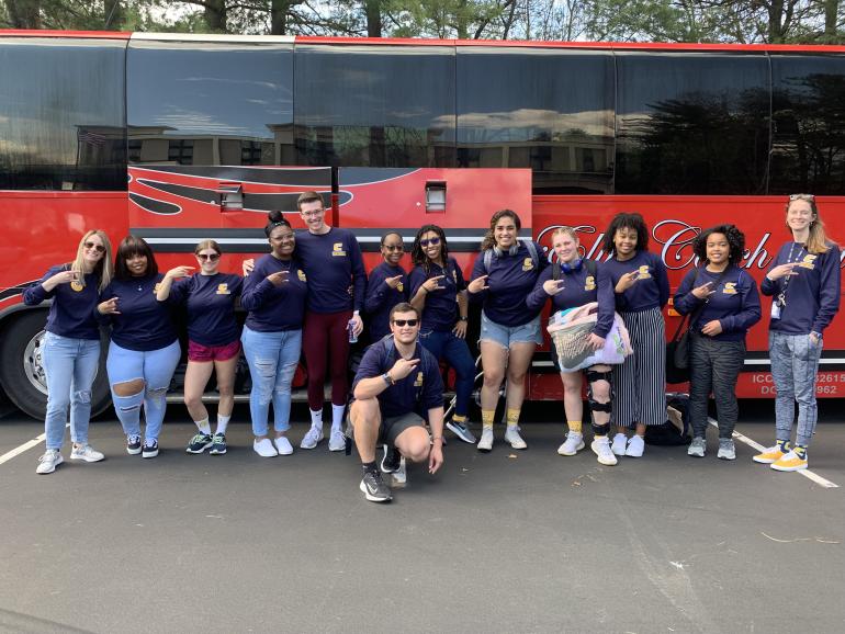 HHP Students in front of a bus 