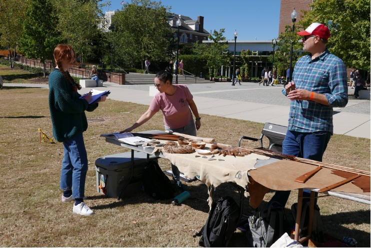 WCTL grants image3 Three students gathered around a table displaying ancient hunting tools.