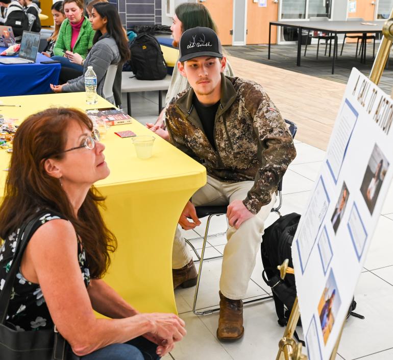 Woman and Man looking at poster board