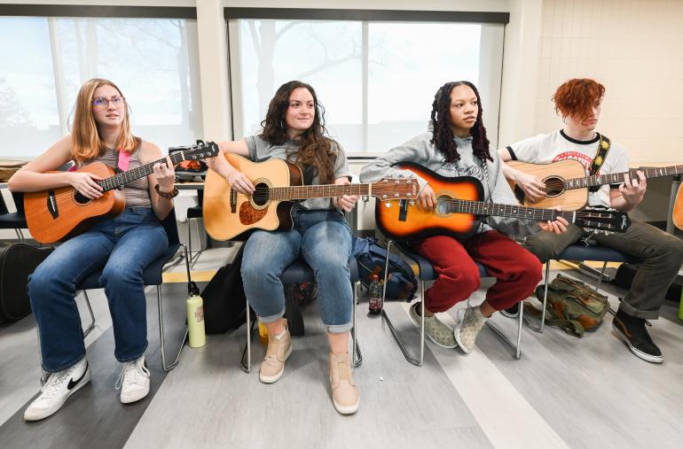 Guitar Class for Music Therapists Photo of Music Therapy students playing guitar
