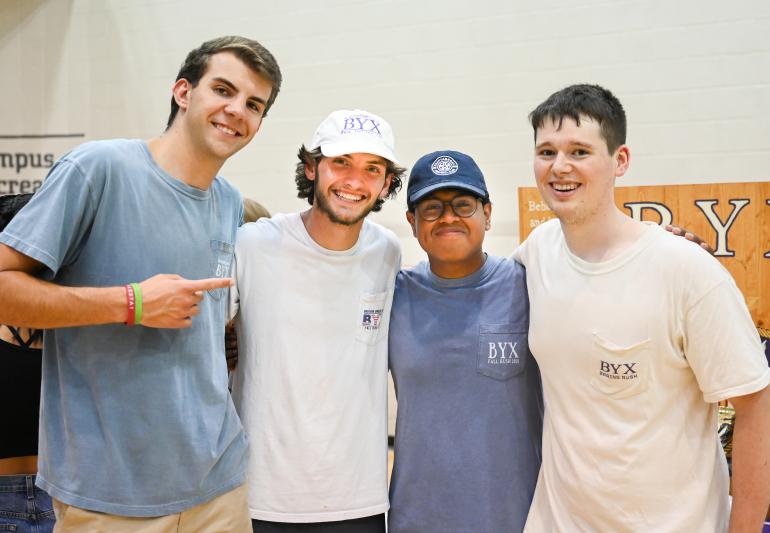 4 members of Beta Upsilon Chi pose for a photo