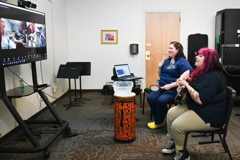 Photo of students participating in telehealth on a large screen