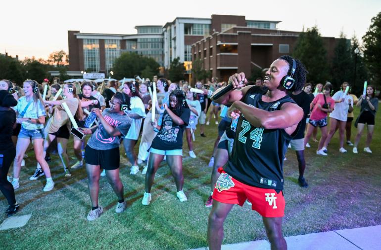Students and dj dancing on Chamberlain field