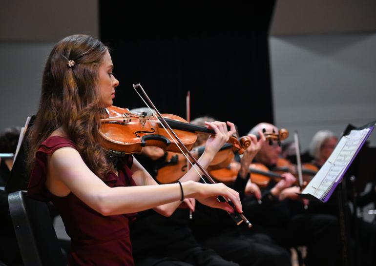 Close-up of violin section of the UTC Symphony Orchestra