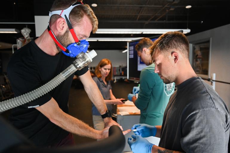 Student on treadmill with oxygen mask