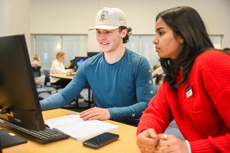 Tutor helping a student in the Math Plaza