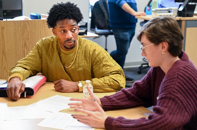 Tutor helping a student in the Math Plaza