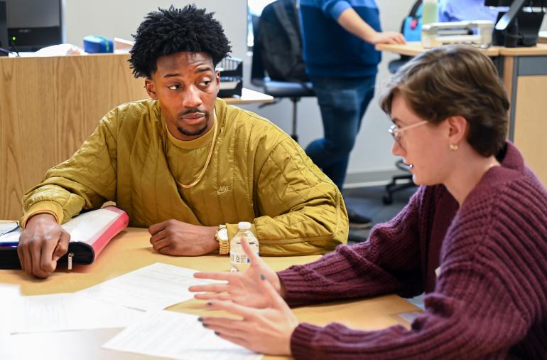 Tutor helping a student in the Math Plaza