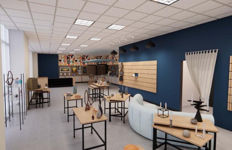 Interior view of the proposed design for the Mocs Marketplace showing a blue wall, free standing display tables and seating.