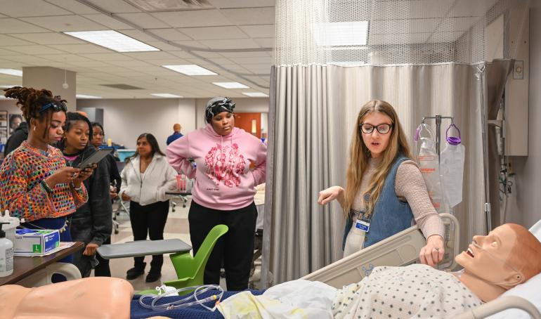 University High Nursing School visit with two students watching a clinical demostration