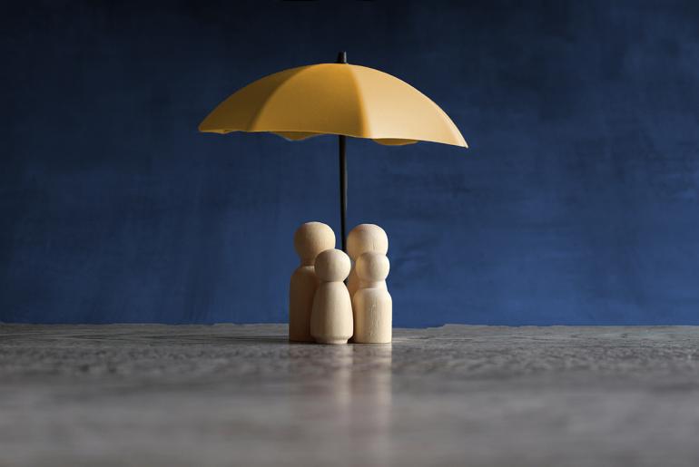 Protection from Harm Wooden dolls under utc gold umbrella