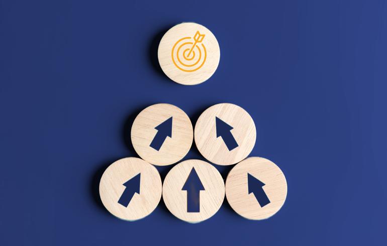 Opportunities for growth five circular wooden blocks with arrows pointing to one circular wooden block with a target