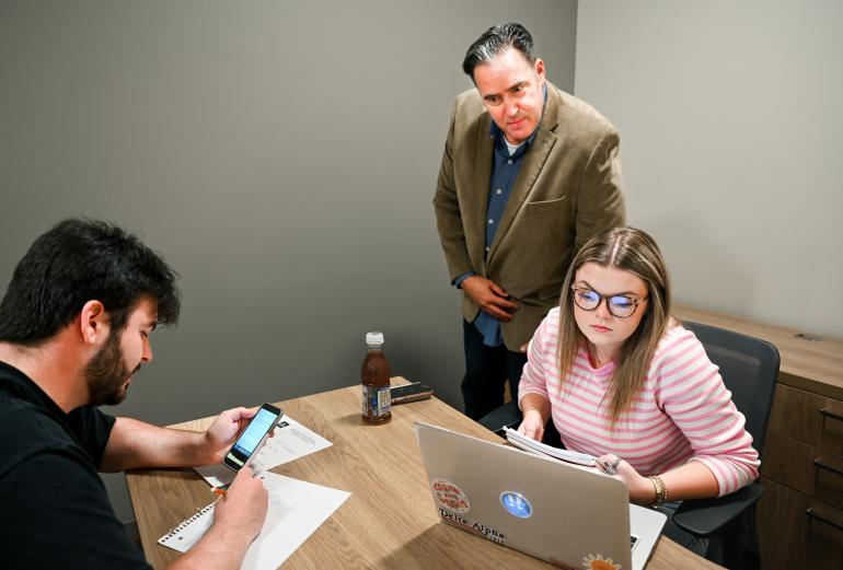 Business Negotiations class Students in lab working on sales project