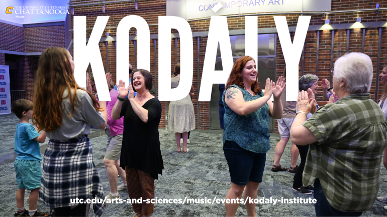 Kodaly 2025 People standing around a room, clapping.