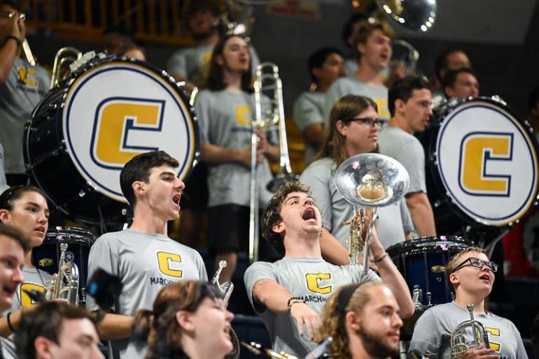 utc pep band members cheering at a game