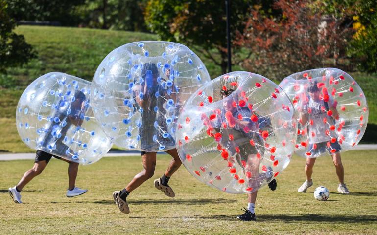 UTC students in red and blue inflatable balls