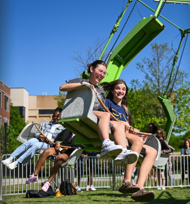 two students riding a carnival ride