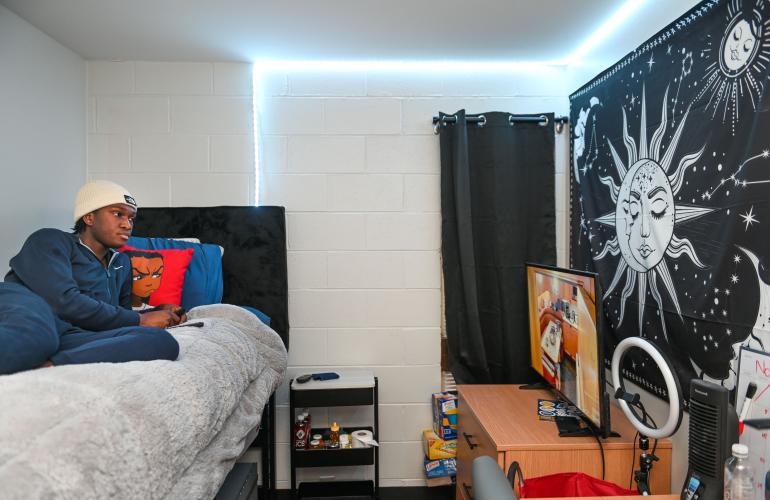 Boling student on bed