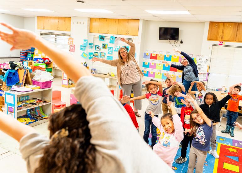 An ABC Teaching Artist leads a happy classroom in movement