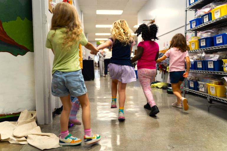 A group of students skips down the hallway together