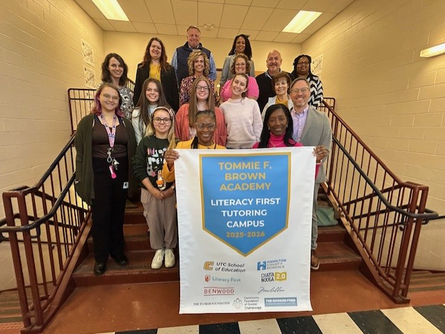 Literacy First group holding a banner