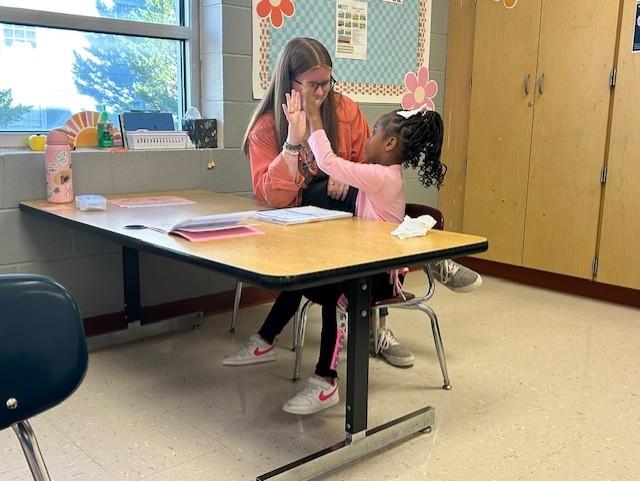 Tutor and student high five