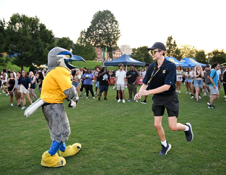 Male UTC student dancing with Scrappy