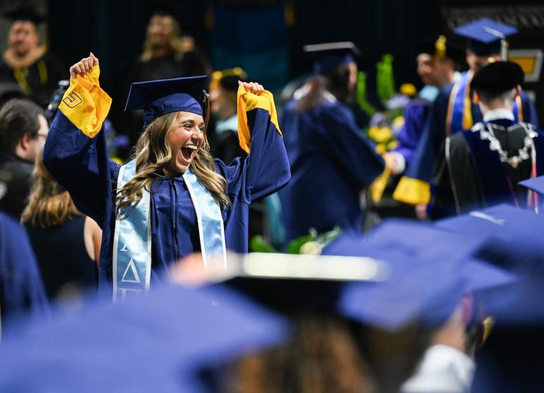UTC undergraduate ceremony featuring a female student celebrating 