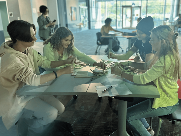 A&SRC students collaborate on a team-building activity, working together to solve a hands-on challenge.