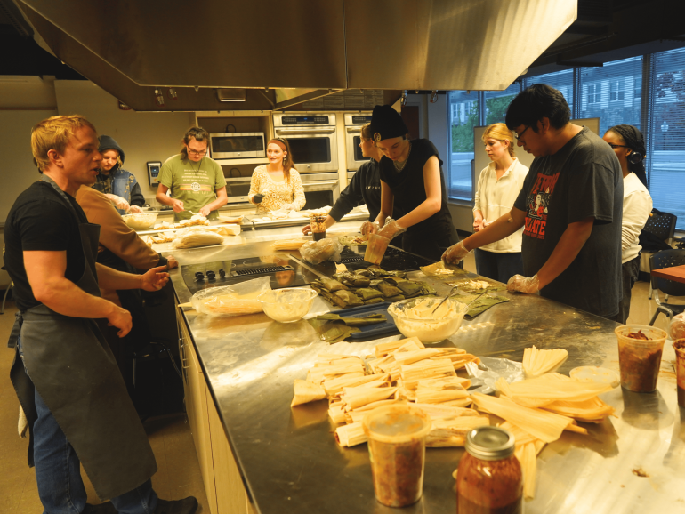 Students prepare tamales together in a campus kitchen as part of an A&SRC cultural learning activity